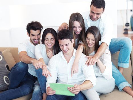 group of friends taking selfie photo with tablet at modern home indoors