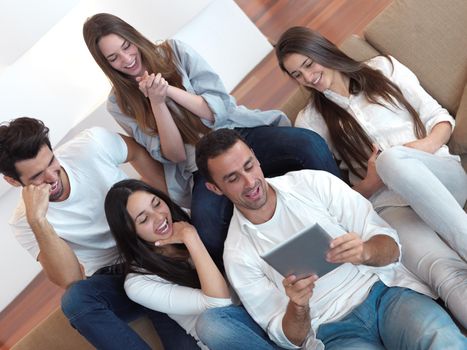 group of friends taking selfie photo with tablet at modern home indoors