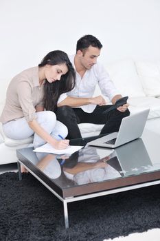 joyful couple relax and work on laptop computer at modern living room indoor home