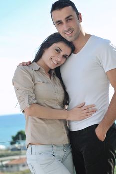 happy young couple in love have romance  relax on balcony outdoor with ocean and blue sky in background