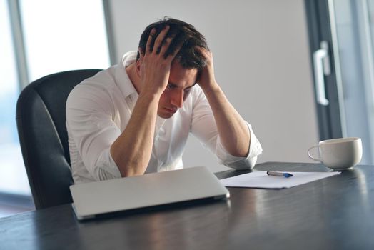 frustrated with problems young business man working on laptop computer at home