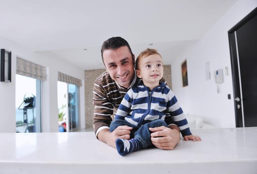 portrait of a happy father and son together in modern living room home indoor
