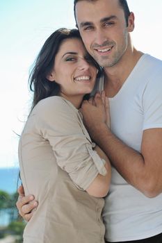 happy young couple in love have romance  relax on balcony outdoor with ocean and blue sky in background