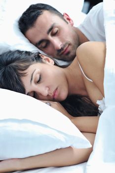 happy young healthy people  couple have good time in their bedroom make love and sleep