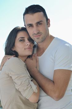 happy young couple in love have romance  relax on balcony outdoor with ocean and blue sky in background