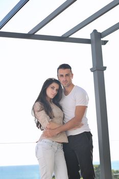 happy young couple in love have romance  relax on balcony outdoor with ocean and blue sky in background