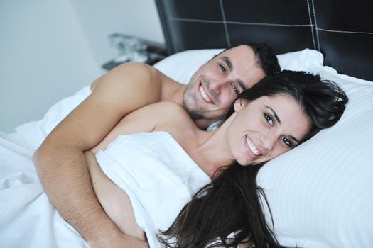 happy young healthy people  couple have good time in their bedroom make love and sleep