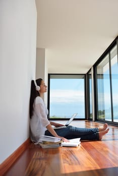 beautiful young woman relax and work on laptop computer while working on laptop computer and read book at home