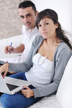 joyful couple relax and work on laptop computer at modern living room indoor home