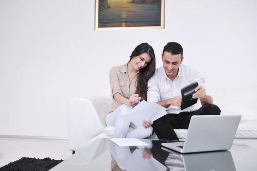 joyful couple relax and work on laptop computer at modern living room indoor home