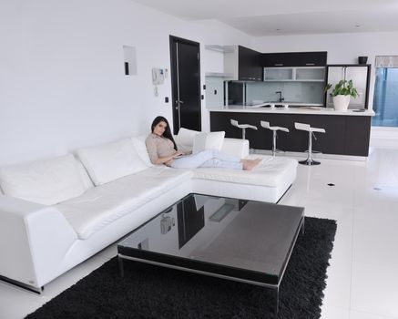 relaxed young woman working on laptop computer in bright  home indoor