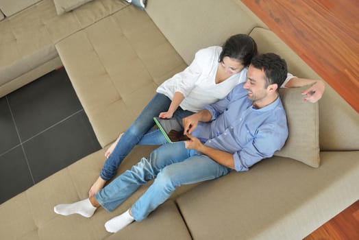 happy young couple at modern home using tablet computer