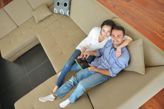 happy young couple at modern home using tablet computer