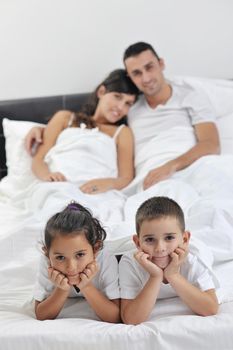 happy young Family in their bedroom have fun and play in bed