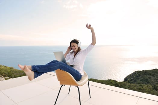 beautiful young woman relax and work on laptop computer while working on laptop computer and read book at home