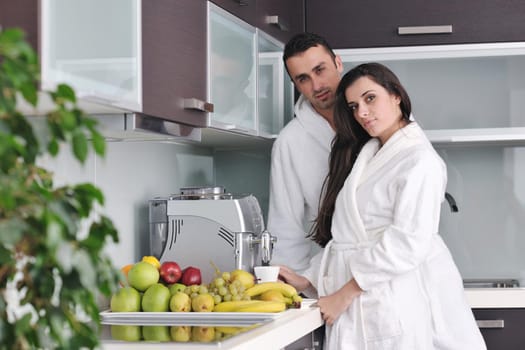 Young love couple taking fresh morning cup of coffee in the modern appartment