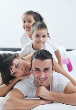 happy young Family in their bedroom have fun and play in bed