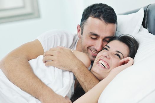 happy young healthy people  couple have good time in their bedroom make love and sleep