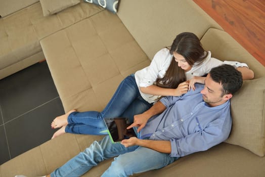 happy young couple at modern home using tablet computer