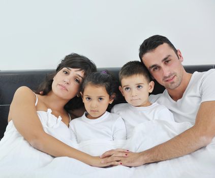 happy young Family in their bedroom have fun and play in bed