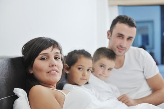 happy young Family in their bedroom have fun and play in bed