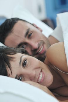 happy young healthy people  couple have good time in their bedroom make love and sleep