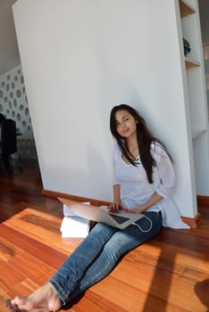beautiful young woman relax and work on laptop computer modern  home office