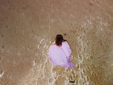 Aerial drone footage of a pink salt lake on a beautiful summer evening. Aerial view of a dried pink salt lake on a beautiful summer evening. Aerial view of a drying out salt lake.