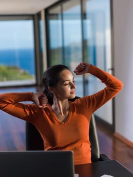 beautiful young woman relax and work on laptop computer modern  home office