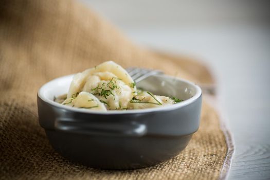 boiled dumplings with meat filling in a bowl on the table