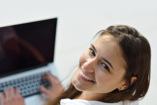 beautiful young woman relax and work on laptop computer modern  home office