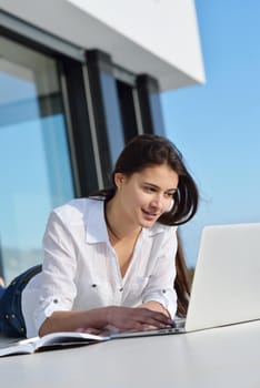 beautiful young woman relax and work on laptop computer modern  home office