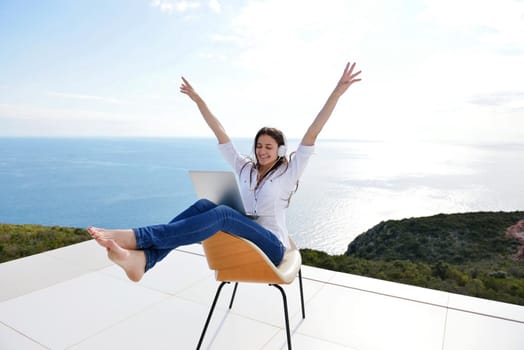 beautiful young woman relax and work on laptop computer while working on laptop computer and read book at home