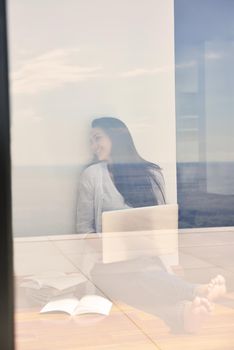 beautiful young woman relax and work on laptop computer modern  home office