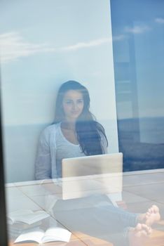 beautiful young woman relax and work on laptop computer modern  home office