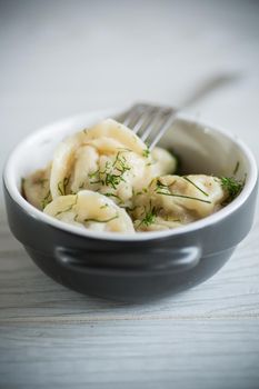 boiled dumplings with meat filling in a bowl on the table