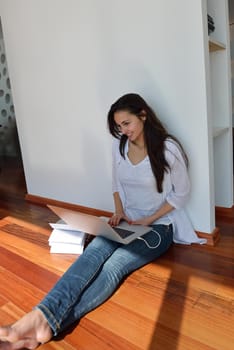 beautiful young woman relax and work on laptop computer modern  home office