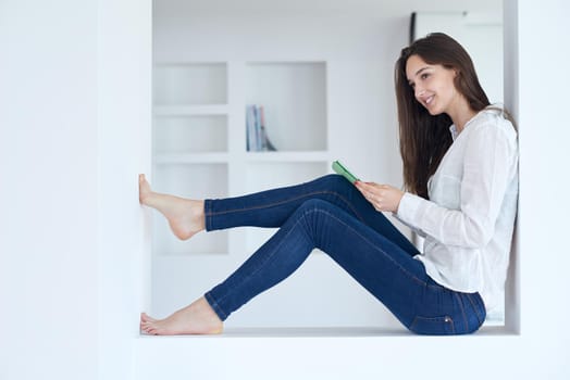 woman at home using tablet computer