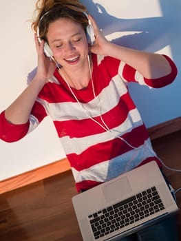 beautiful young woman relax and work on laptop computer while working on laptop computer and read book at home