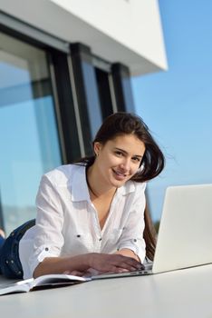 beautiful young woman relax and work on laptop computer modern  home office