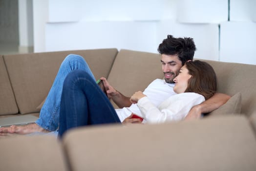 romantic relaxed young couple at modern home using tablet computer