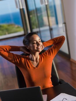 beautiful young woman relax and work on laptop computer modern  home office