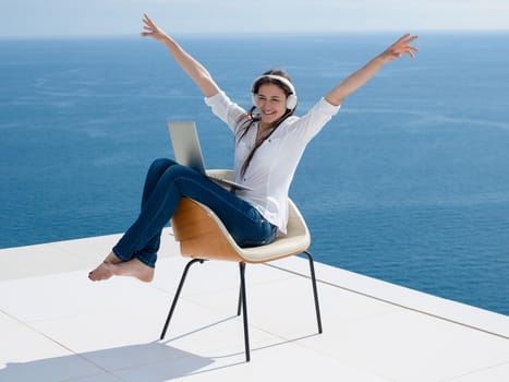 beautiful young woman relax and work on laptop computer while working on laptop computer and read book at home