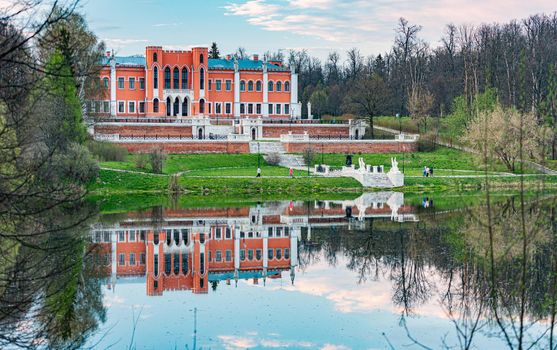 Beautiful old buidling in Russian with lake in foreground and sky with clouds in background