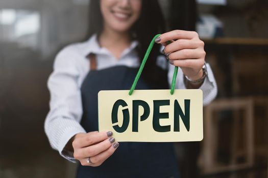 At her coffee shop, Smiling Small Business Owner Turning Around Open shop back to open the shop after COVID-19