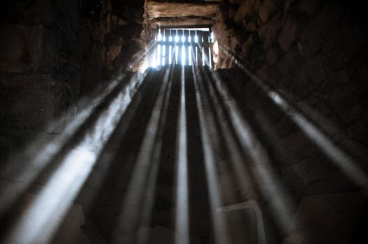 sun rays beaming through the jail window into the cell