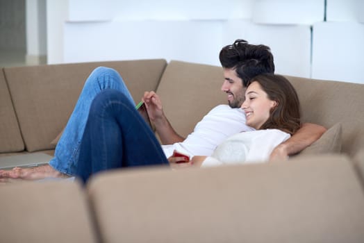 romantic relaxed young couple at modern home using tablet computer