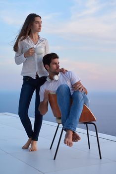 happy young romantic couple have fun relax smile at modern home outdoor terace balcony terace