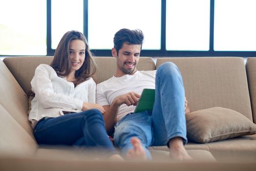 romantic relaxed young couple at modern home using tablet computer