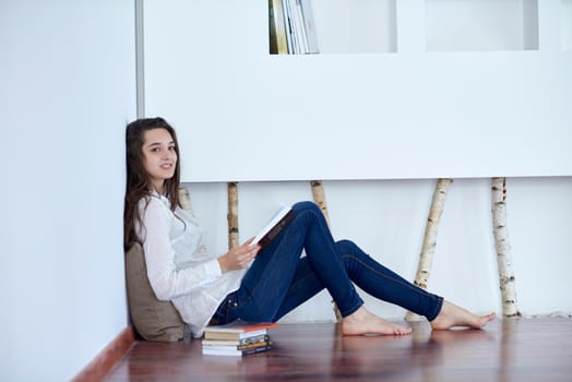 beautiful young woman relax and work on laptop computer modern  home office while listening musin on white headphones